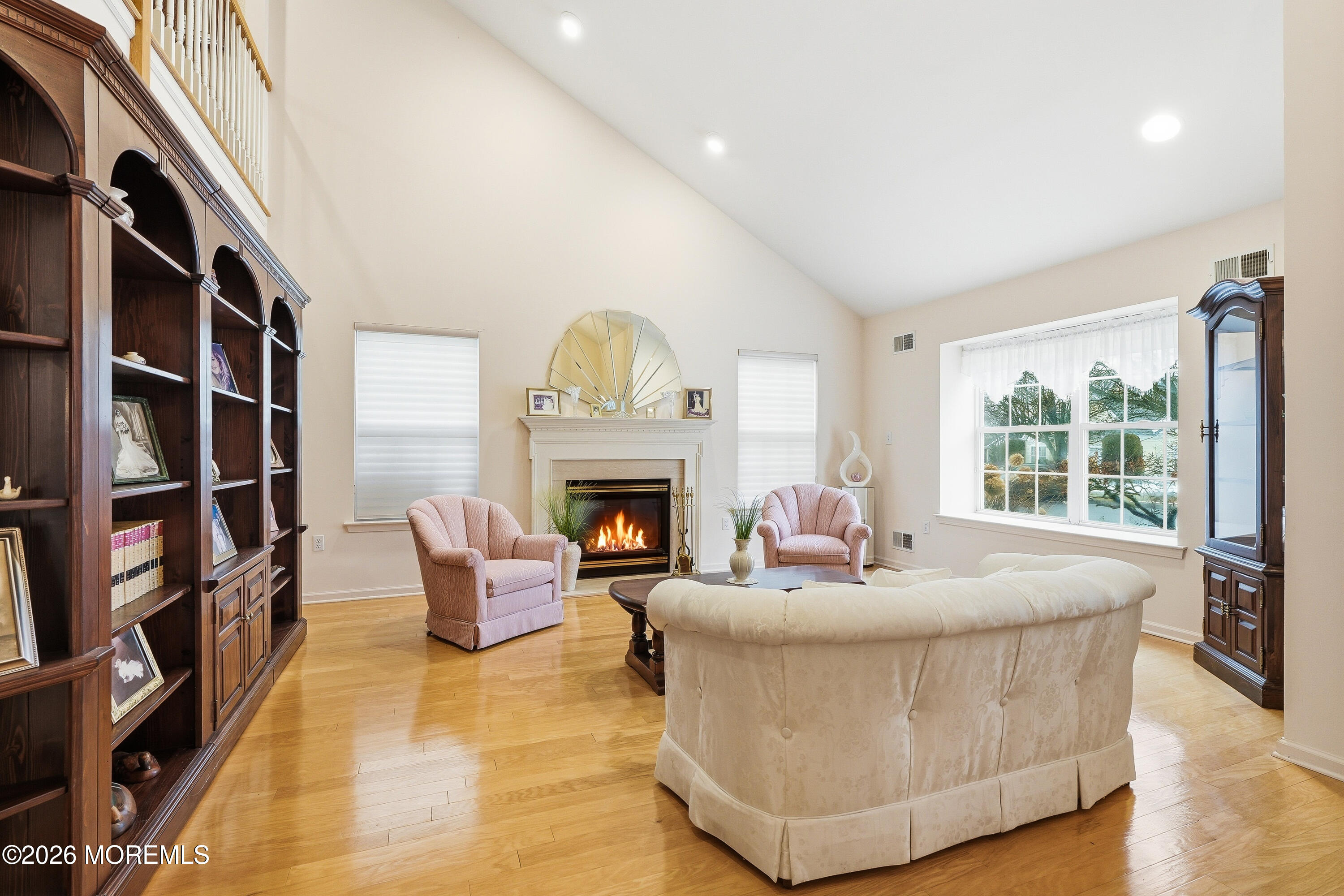8 Casco Court Lakewood, NJ 08701 - Photo 7 of 56 a living room with fireplace furniture and a book shelf