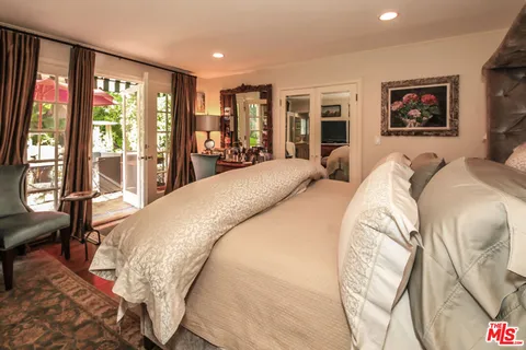 a bed sitting in a bedroom next to a large window