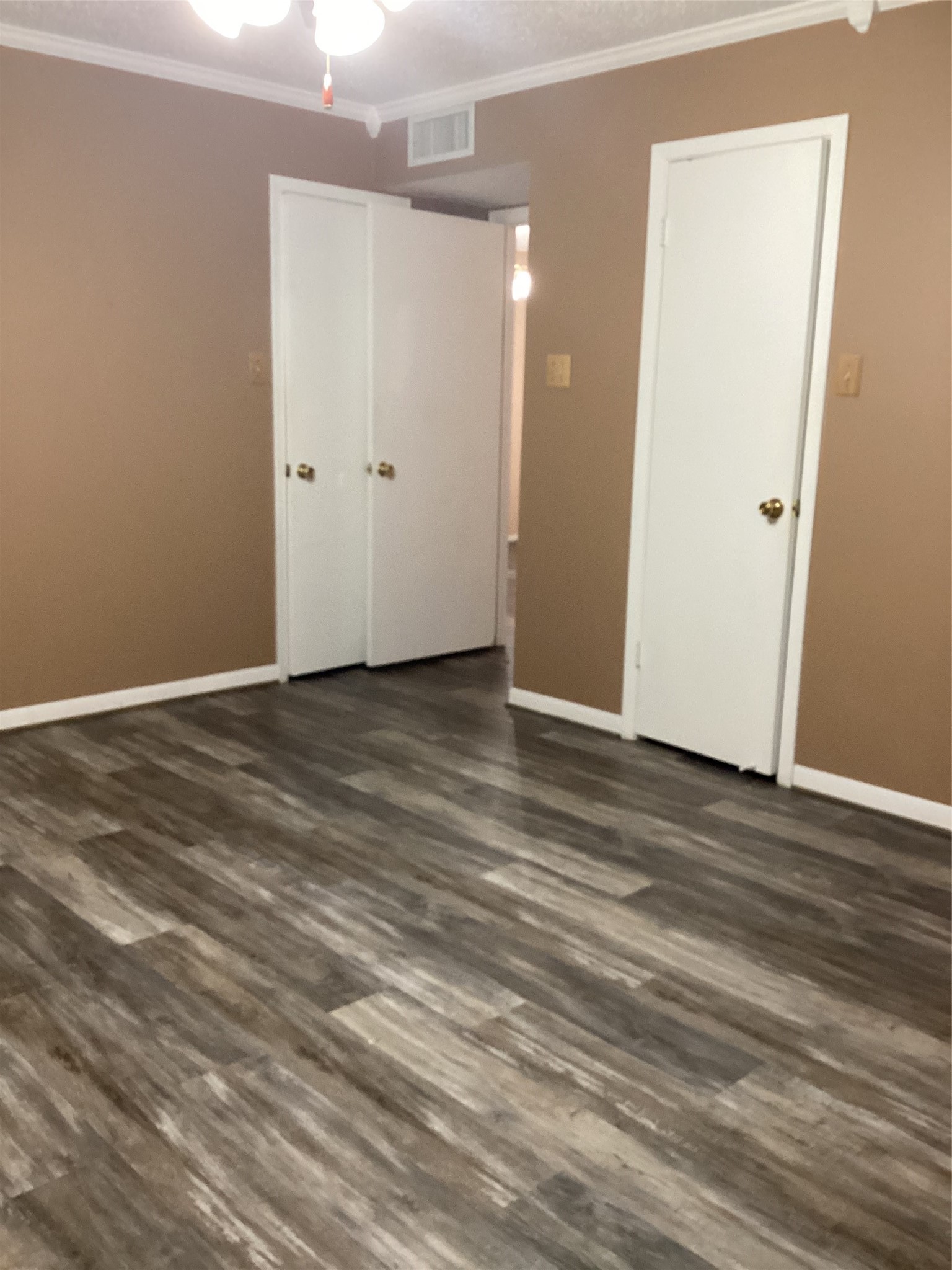 1252 Eagle Lake Road, Unit 8 Sealy, TX 77474 - Photo 12 of 18 This bathroom features a modern design with wood-look flooring, dark cabinetry, a large mirror with bright lighting, and a neutral color palette.