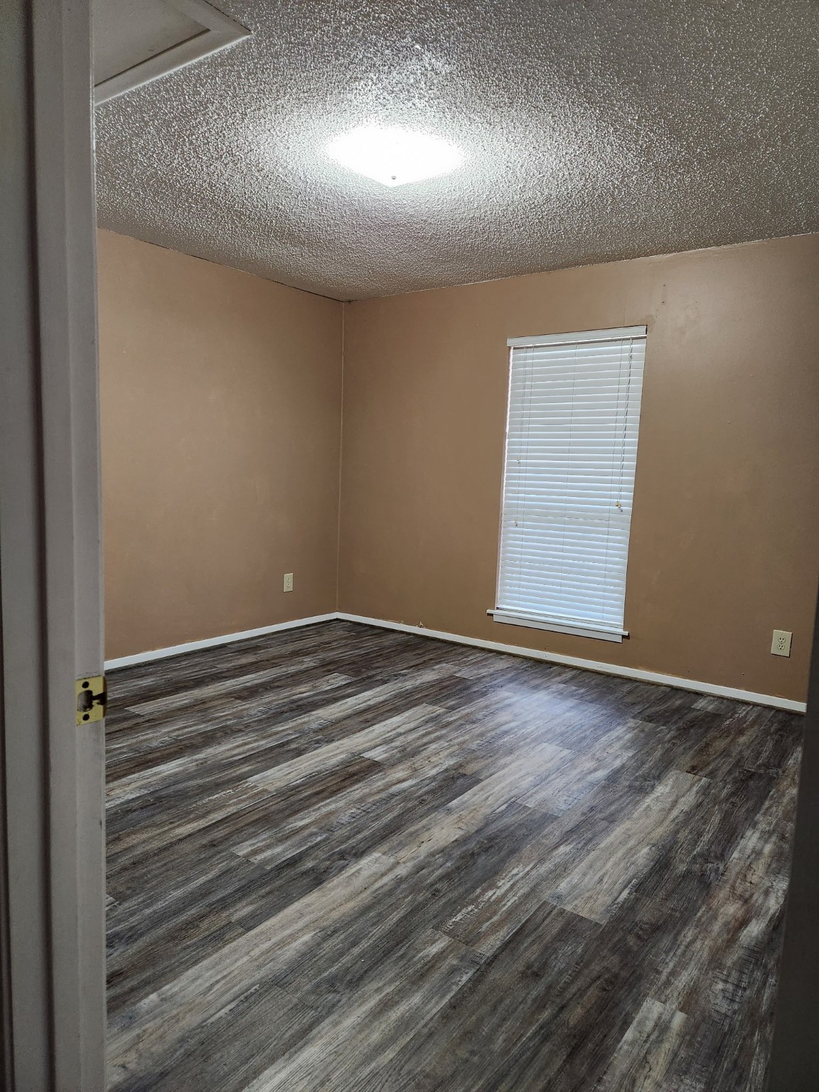 1252 Eagle Lake Road, Unit 8 Sealy, TX 77474 - Photo 14 of 18 an empty room with wooden floor and windows