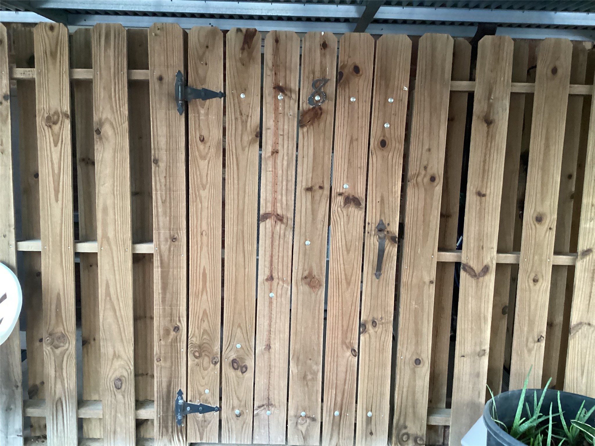 1252 Eagle Lake Road, Unit 8 Sealy, TX 77474 - Photo 18 of 18 This wooden gate offers a rustic charm, enhancing both security and style for your outdoor space. Back patio partially covered with covered parking space. Perfect for creating a warm, inviting entrance.