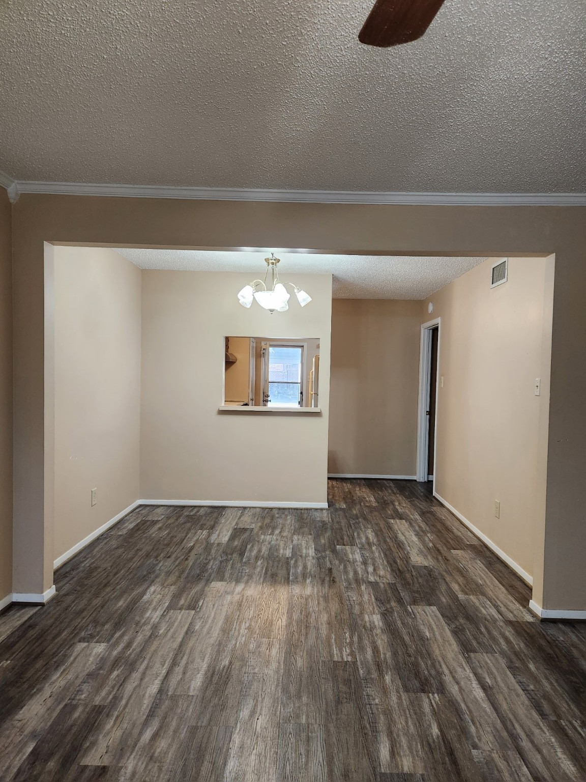 1252 Eagle Lake Road, Unit 8 Sealy, TX 77474 - Photo 4 of 18 a view of an empty room with wooden floor and a window