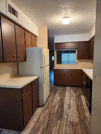 a kitchen with a refrigerator and a sink