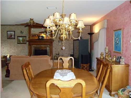 199 Country Club Road Shalimar, FL 32579 - Photo 11 of 21 a dining room with furniture a chandelier and wooden floor