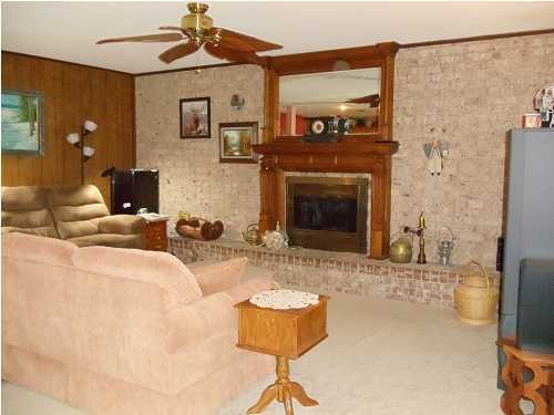 199 Country Club Road Shalimar, FL 32579 - Photo 14 of 21 a living room with furniture a flat screen tv and a fireplace