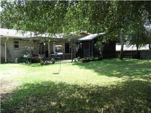 199 Country Club Road Shalimar, FL 32579 - Photo 19 of 21 a backyard of a house with yard and outdoor seating