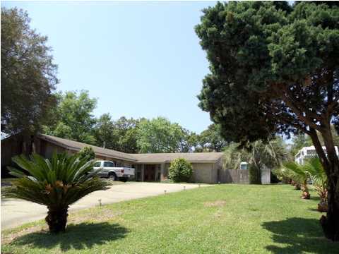 199 Country Club Road Shalimar, FL 32579 - Photo 3 of 21 a view of a backyard with a garden and plants