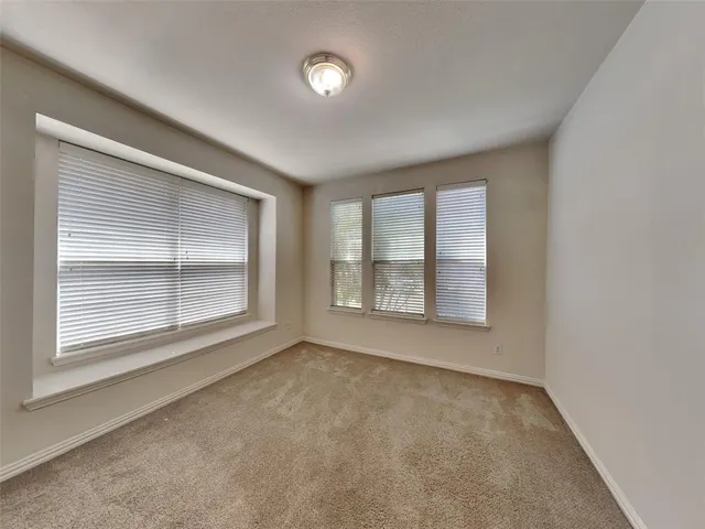 an empty room with a empty space and windows