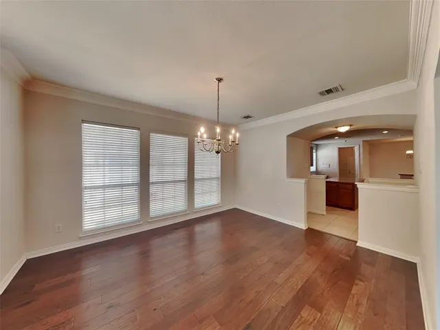 a view of a room with wooden floor and windows