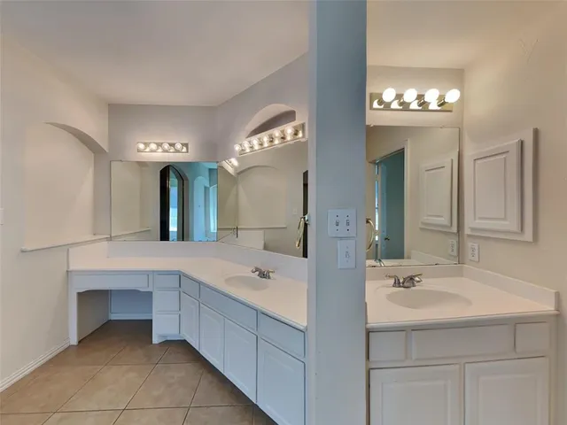 a spacious bathroom with a sink double vanity and a mirror