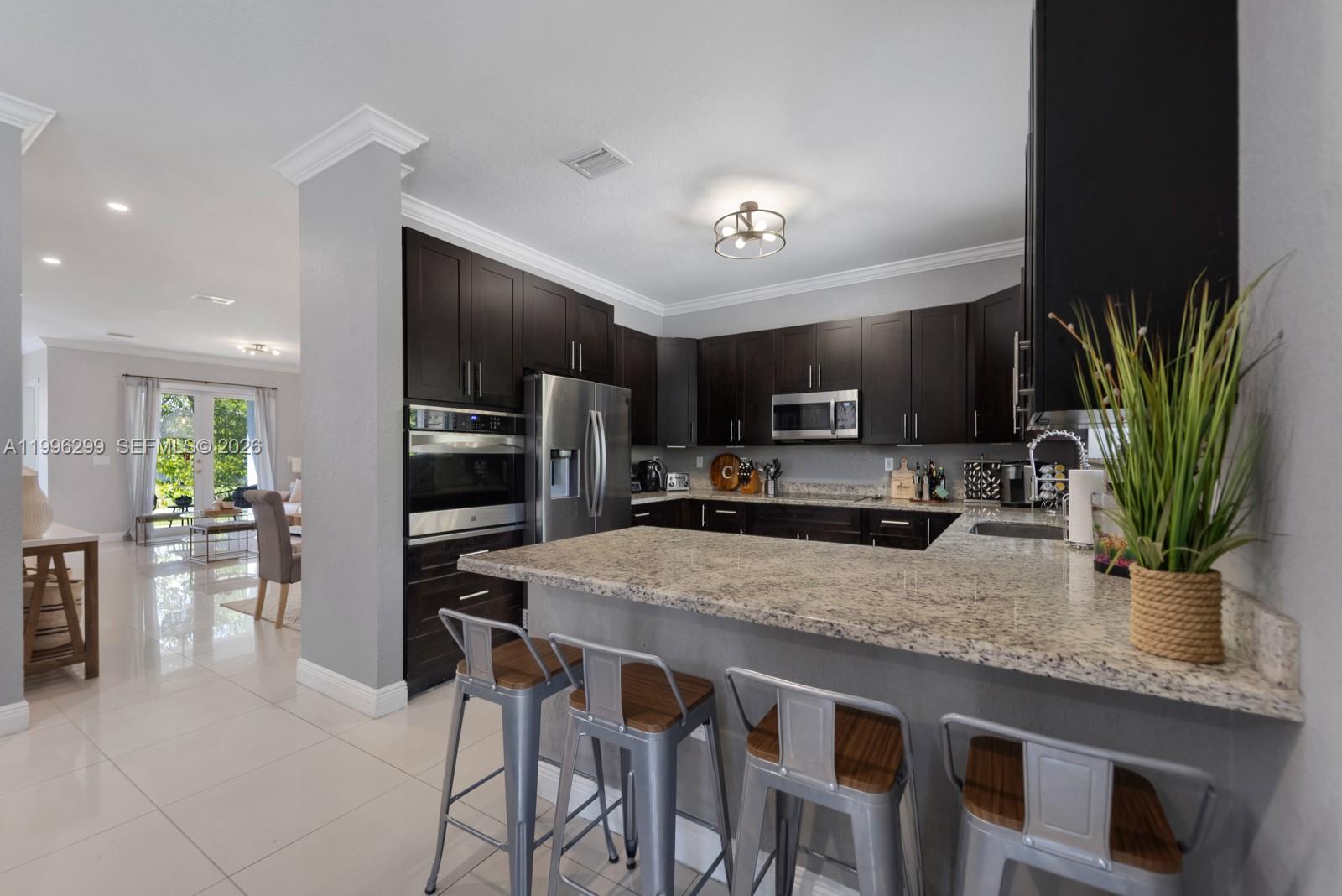 19781 Southwest 84th Court Cutler Bay, FL 33189 - Photo 11 of 53 a kitchen with a table and chairs in it