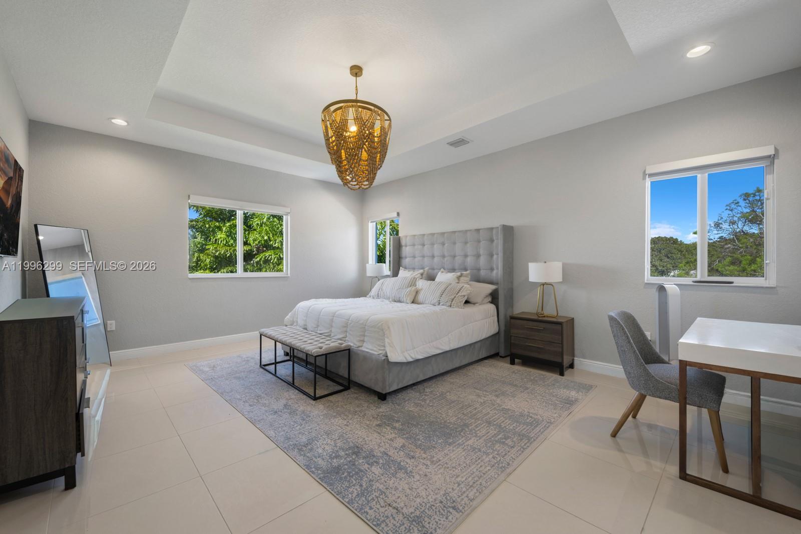 19781 Southwest 84th Court Cutler Bay, FL 33189 - Photo 25 of 53 a spacious bedroom with a bed and a window