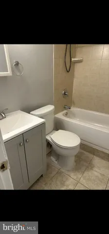 a bathroom with a toilet a sink and bathtub