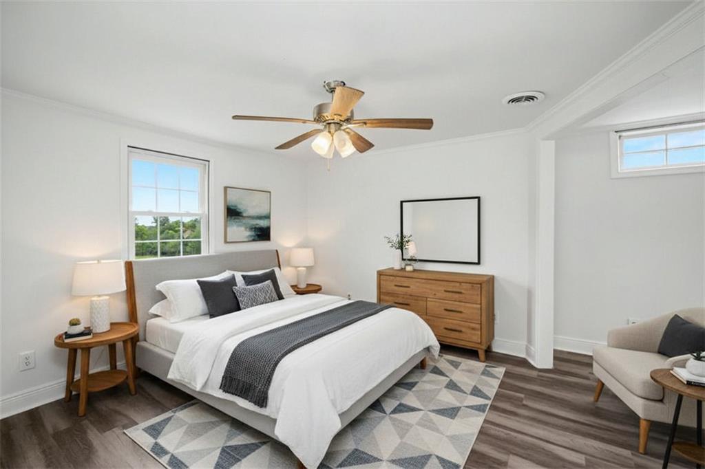 1605 Shackelford Road Griffin, GA 30224 - Photo 5 of 51 a bedroom with a large bed and a chandelier