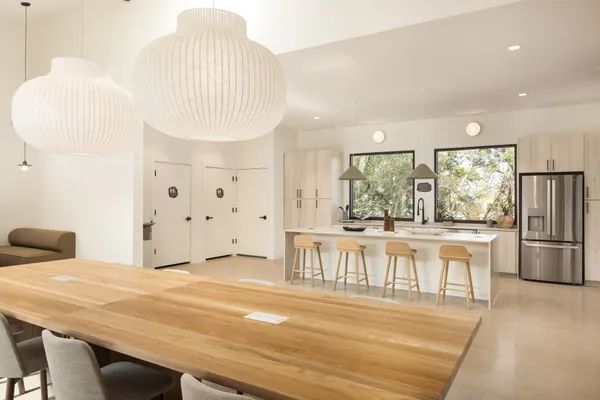 a large white kitchen with a large window