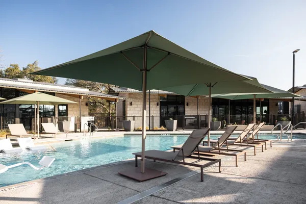 a patio with a table and chairs under an umbrella