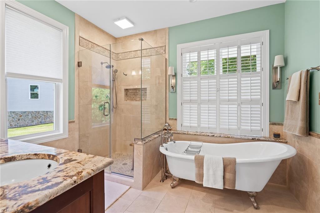 133 Lake View Road Prospect Hill, NC 27314 - Photo 24 of 50 Updated Primary Bathroom with Travertine Tile and Clawfoot tub