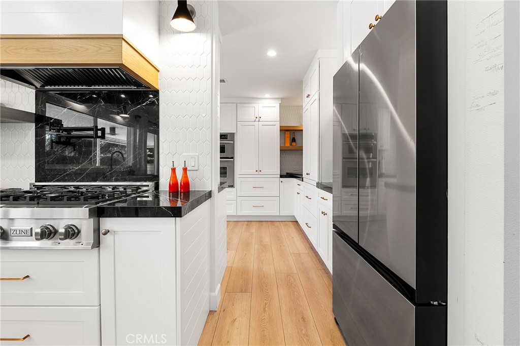 24701 Nympha Drive Mission Viejo, CA 92691 - Photo 19 of 75 a view of a kitchen with kitchen island a counter top space a sink and cabinets