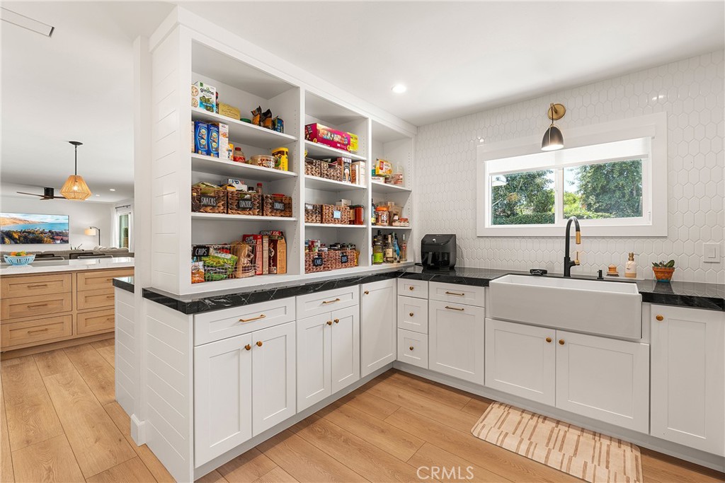 24701 Nympha Drive Mission Viejo, CA 92691 - Photo 24 of 75 a kitchen with granite countertop white cabinets and white appliances