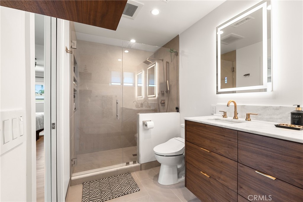 24701 Nympha Drive Mission Viejo, CA 92691 - Photo 46 of 75 a bathroom with a granite countertop sink toilet mirror and bathtub