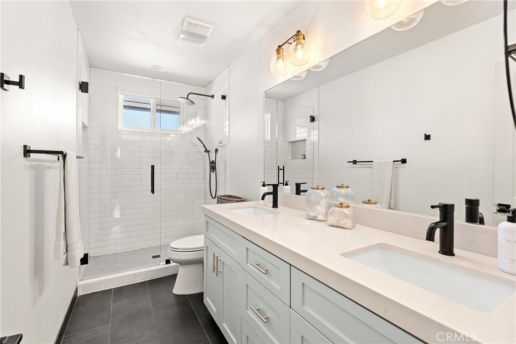 24701 Nympha Drive Mission Viejo, CA 92691 - Photo 54 of 75 a spacious bathroom with a double vanity sink toilet mirror and shower
