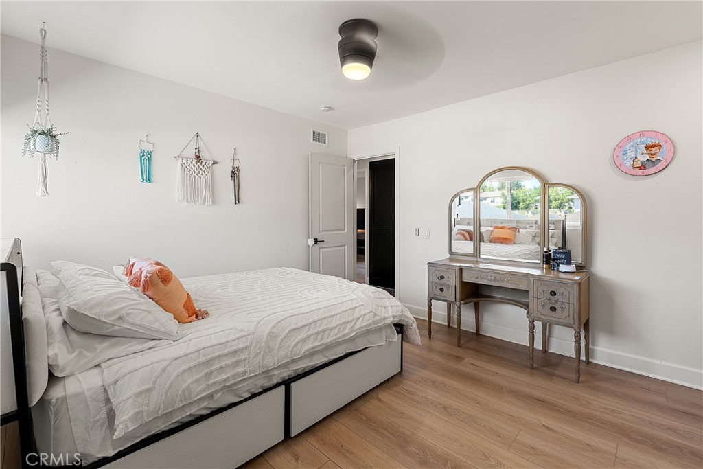 24701 Nympha Drive Mission Viejo, CA 92691 - Photo 64 of 75 a bedroom with a bed and a chandelier