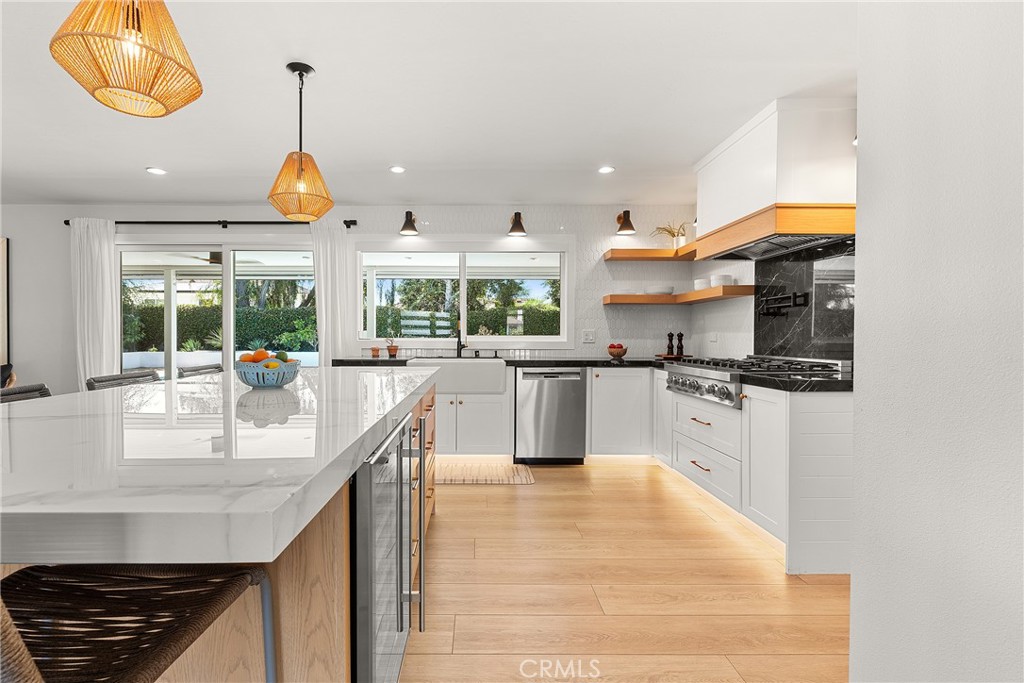 24701 Nympha Drive Mission Viejo, CA 92691 - Photo 10 of 75 a kitchen with stainless steel appliances granite countertop a sink a stove and a wooden floors