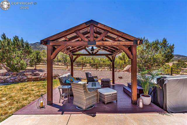 182 Raptor Court Canon City, CO 81212 - Photo 32 of 50 The backyard features a composite deck added in 2022 along with a 12? x 12? gazebo that creates a comfortable and welcoming outdoor living area.