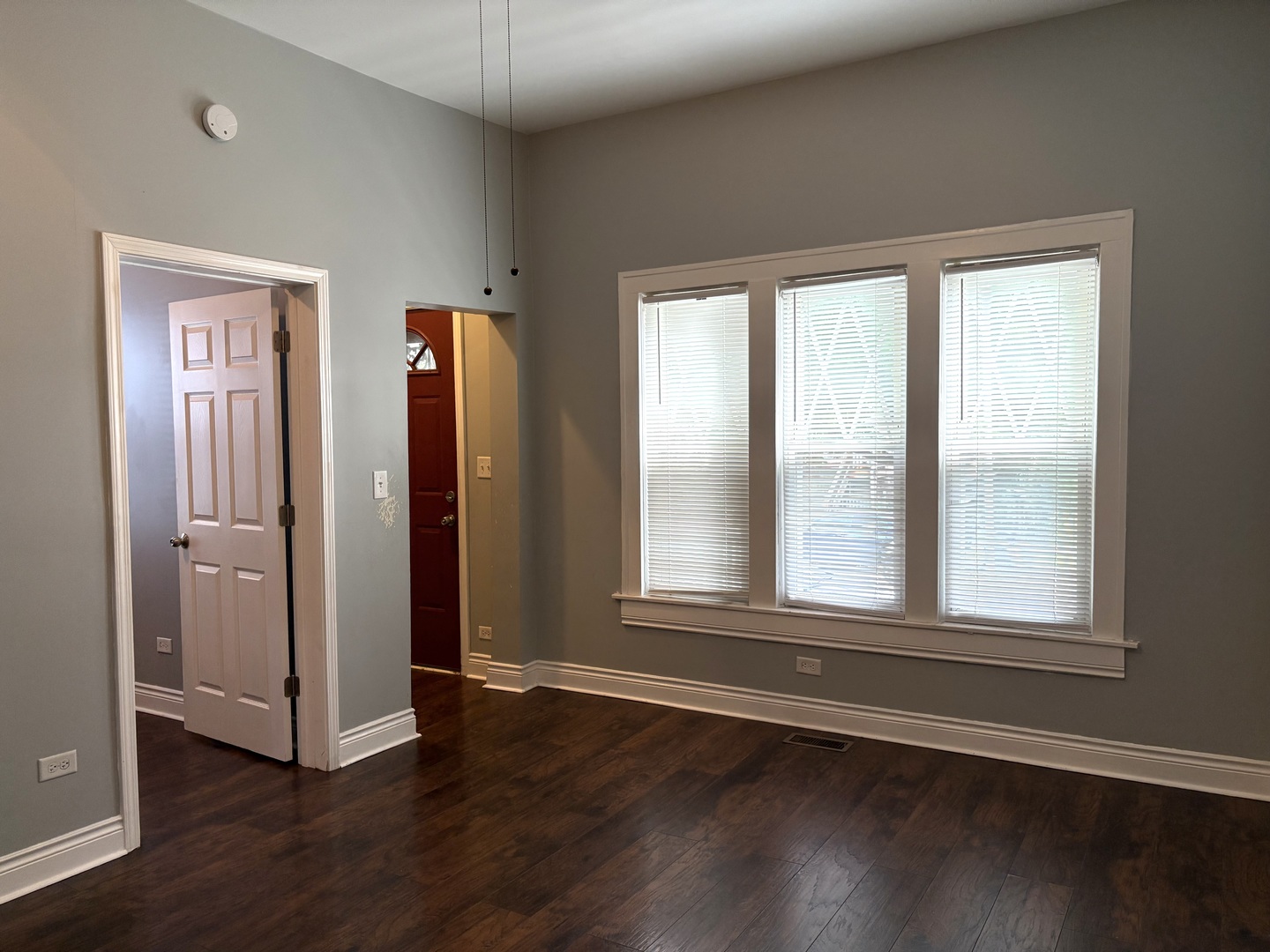 734 West 48th Place Chicago, IL 60609 - Photo 5 of 33 an empty room with wooden floor and windows