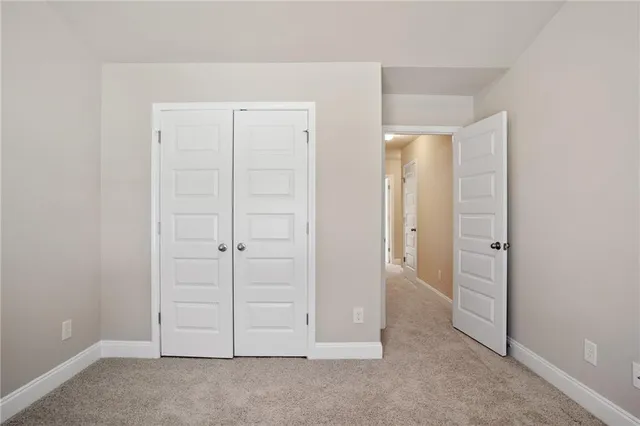 an empty room with closet area