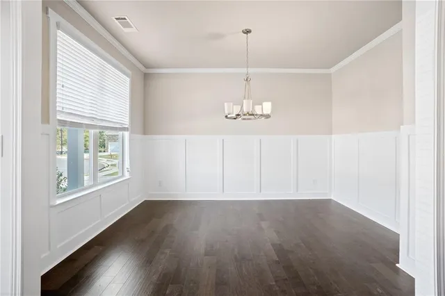 a view of wooden floor and windows in a room
