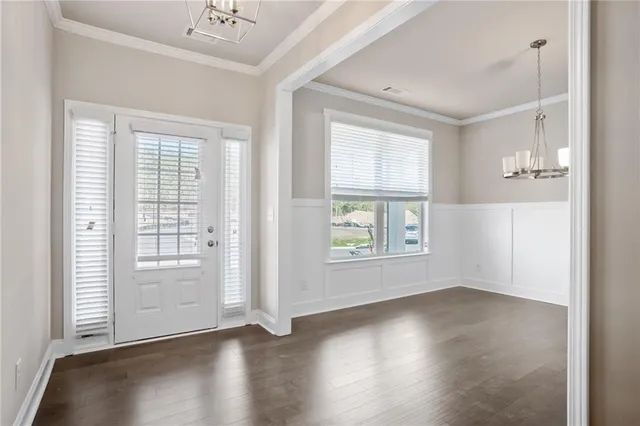 an empty room with wooden floor and windows with curtains view