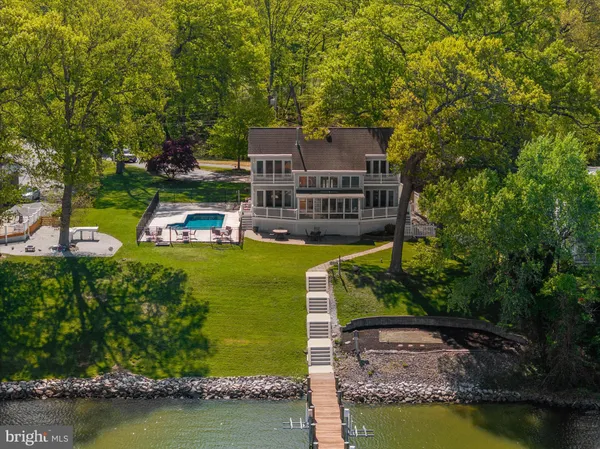 an aerial view of a house with a garden and lake view