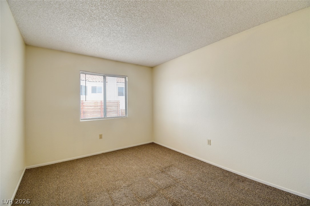 5 Tarryall Terrace Henderson, NV 89074 - Photo 25 of 44 A well-lit room awaits with neutral walls and a textured ceiling, ready for personal touches.
