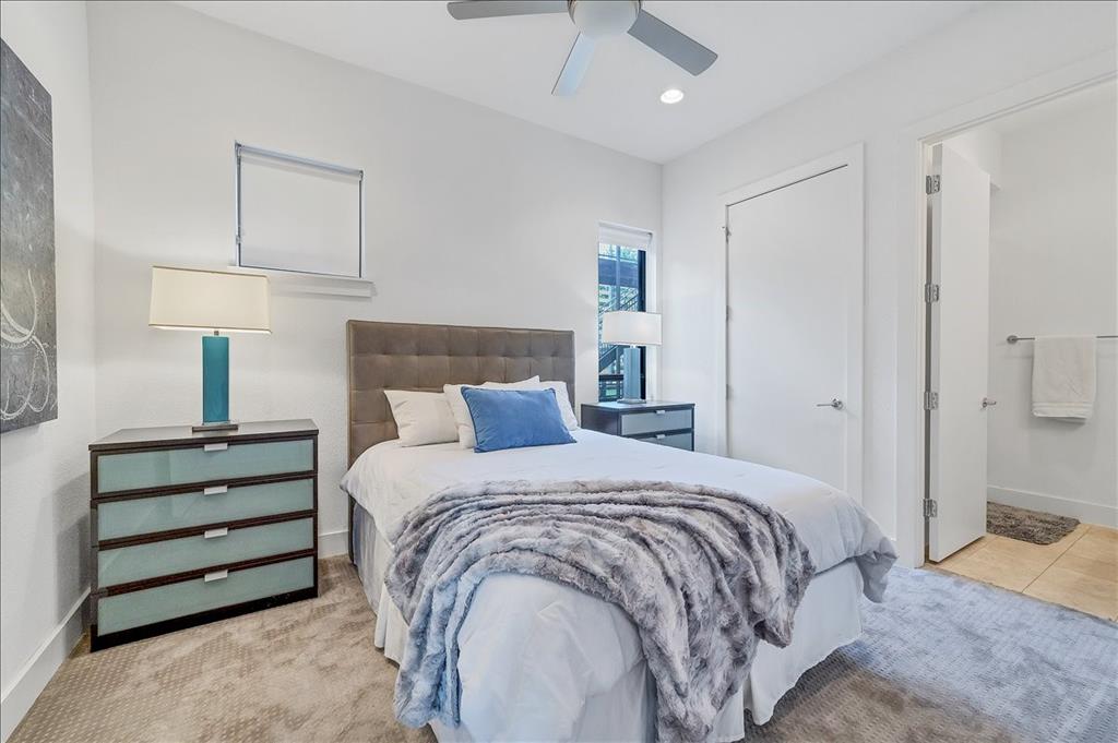 1101 Ivean Pearson Road, Unit A102 Lago Vista, TX 78645 - Photo 16 of 31 Bedroom featuring a ceiling fan, ensuite bath, recessed lighting, and light carpet