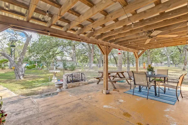 a view of a swimming pool with a table and chairs in patio