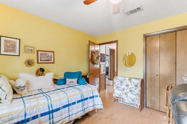 a bedroom with bed and wooden cabinets