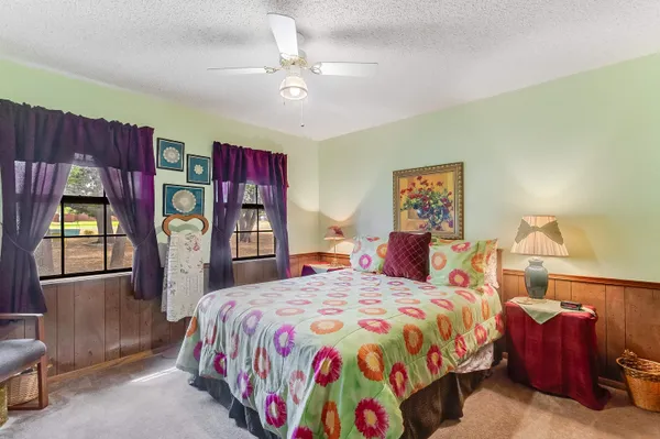 a bedroom with a bed and dresser with mirror