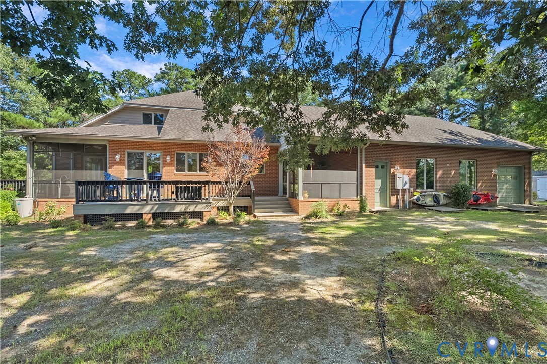 447 Tranquility Road Reedville, VA 22539 - Photo 10 of 82 Brick exterior with multiple windows, a screened p