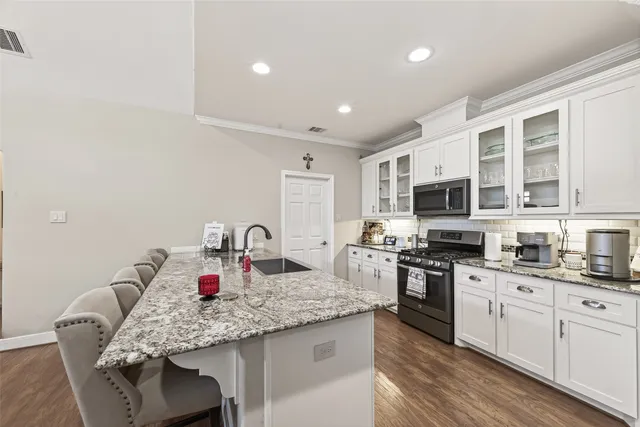 a kitchen with stainless steel appliances granite countertop a stove and a sink