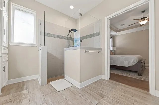 a bathroom with a double vanity sink a mirror and a shower