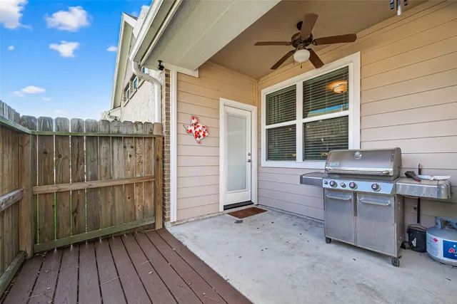 a view of a porch with furniture and floor to ceiling window