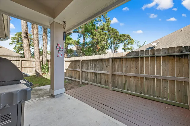 a view of a house with a yard and wooden fence