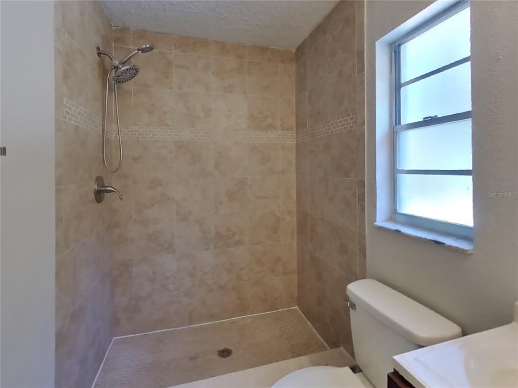 Undisclosed Address Spring Hill, FL 34606 - Photo 11 of 16 a bathroom with a shower and a toilet
