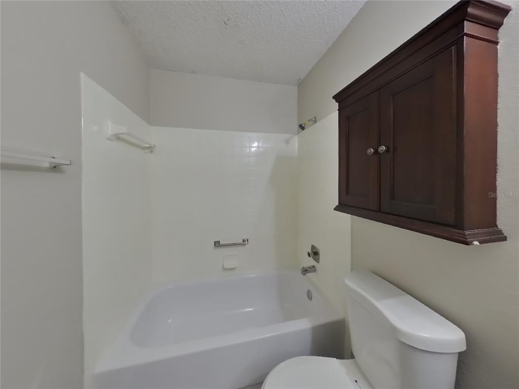 Undisclosed Address Spring Hill, FL 34606 - Photo 15 of 16 a bathroom with a toilet and a bathtub