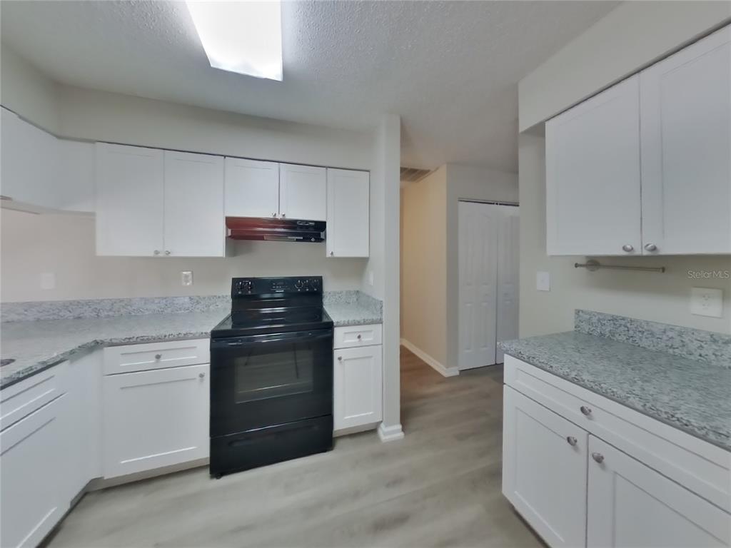 Undisclosed Address Spring Hill, FL 34606 - Photo 6 of 16 a kitchen with a stove and a sink