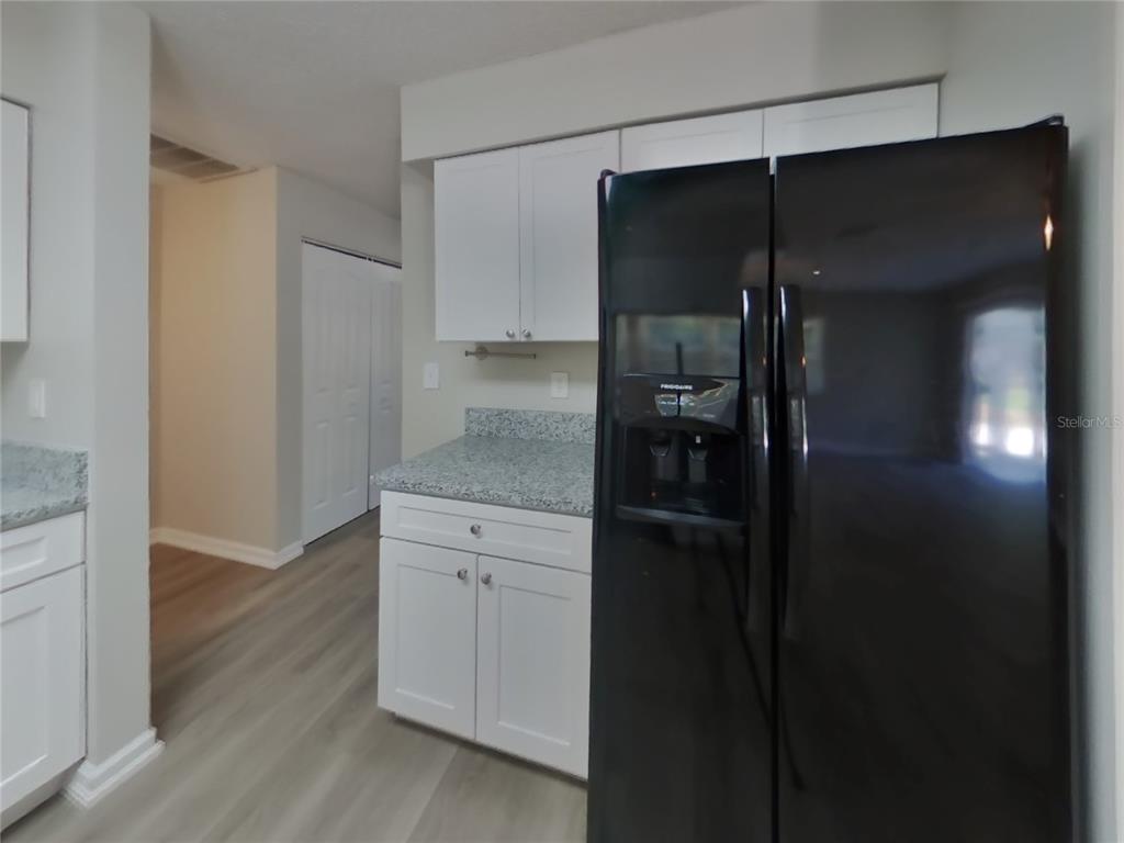 Undisclosed Address Spring Hill, FL 34606 - Photo 7 of 16 a walk in closet with a wooden cabinet