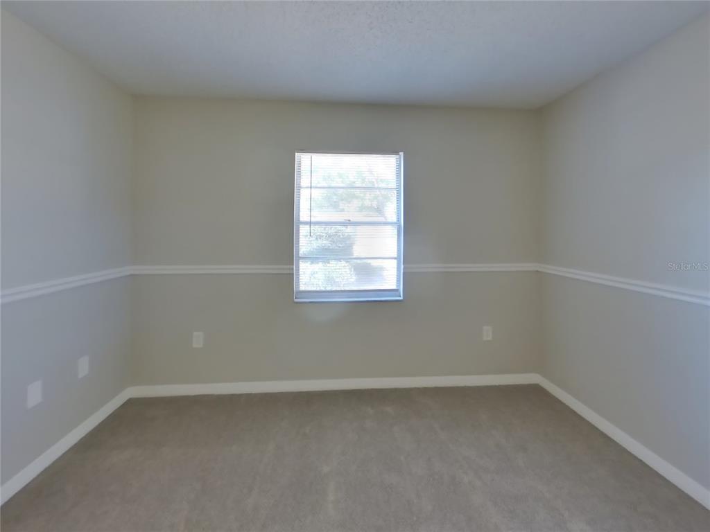 Undisclosed Address Spring Hill, FL 34606 - Photo 9 of 16 an empty room with a window