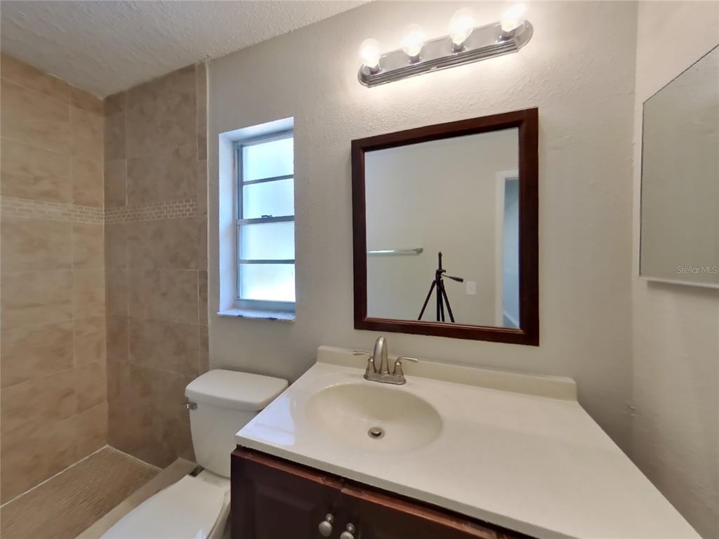 Undisclosed Address Spring Hill, FL 34606 - Photo 10 of 16 a bathroom with a sink and a mirror