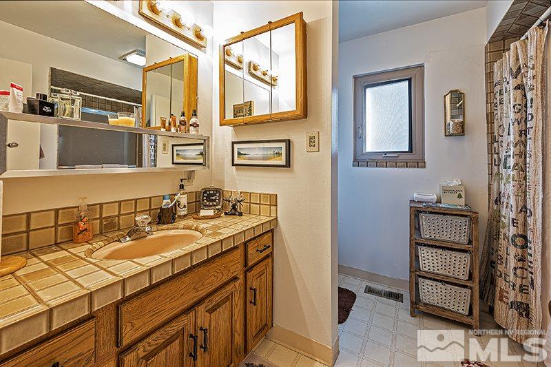 12005 Broken Hill Road Reno, NV 89511 - Photo 11 of 20 a bathroom with a sink and a mirror